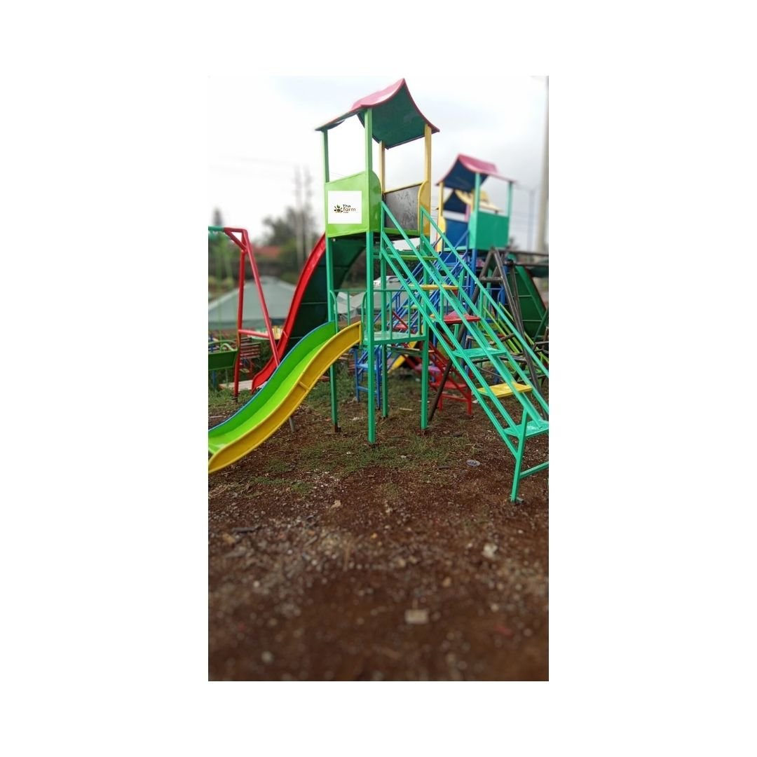 Double Slide with a tall slide for big kids and a shorter slide for small children, featuring bright colors and a sturdy design in an outdoor play area.